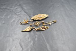 Five yellow metal brooches of various forms and a pendant, four stamped 9ct/375 and the two others