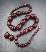A knotted string of graduated cherry amber style beads, approx 30' long and approx 140.7g, and a