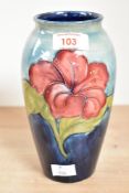 A Moorcroft pottery 'Hibiscus' pattern vase of lobed form, having tube lined decoration and