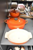 An enamelled cast iron Le Creuset casserole pot with cover, L34cm, sold together with two pans and a