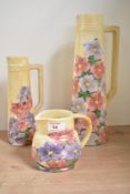 An early 20th century ceramic jug in the Art Deco style, hand painted with floral patterns on a