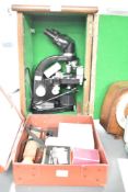 A Leitz Wetzler black binocular microscope with case and accessories, impressed No 708329, h34.