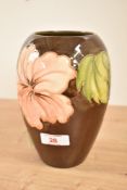 A Moorcroft pottery 'Hibiscus' pattern vase of ovoid form, decorated with floral designs on a washed