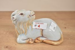 A Chinese porcelain figure of a seated goat or sheep, L13cm