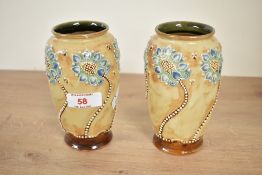 A pair of Doulton 'Lambeth' stoneware vases, decorated in the Art Nouveau style having flowers and