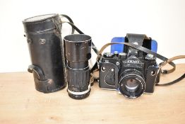 A Zenit camera, sold together with carry case and lens, (4)