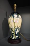 A Moorcroft 'Nivalis' pattern pottery table lamp raised on a circular base, h39cm