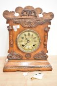 A late 19th century 'Newhavon, USA' oak cased 8 - day mantel clock having brass dial and carved