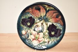 A Moorcroft pottery plate having tub lined decoration, impressed and painted marks to base, w26.5cm