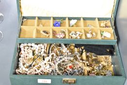 A green faux leather two tier jewellery box, having an assortment of costume jewellery including