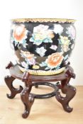 A 20th century Chinese 'Famille Noire' pattern planter, raised on a wooden stand, H21cm (h37cm