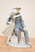 A large Lladro porcelain figure group 'The Kiss' model number 4888, measuring 35cm tall.