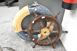 A wooden ship's wheel, h61cm, sold together with a ocean liner life ring, (2)
