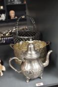 A metal tea pot having shaped handle and spout, decorated with floral patterns, h21cm, sold together