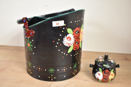 A black metal bucket having hand coloured floral patterns, h25cm, sold together with lidded jar, (