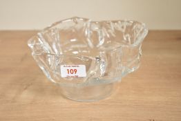 A 20th century clear glass bowl of asymmetrical form having flared edges, w18cm