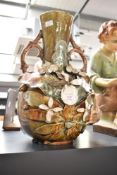 An Art Nouveau style ceramic vase of baluster form, decorated with flowers, foliage and having