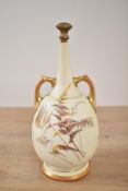 A 19th century Royal Worcester porcelain vase of bottle form, having gilt handles and decorated with