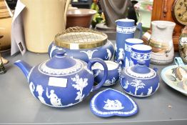 A Wedgwood Jasperware tea pot, decorated with neo-classical motifs on a blue ground, h13cm, sold