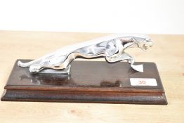 A 20th century Jaguar car mascot raised on a mahogany plinth, L22.5