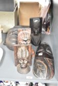 A hand carved wooden African tribal mask, having piercing white eyes, h28cm, sold together with