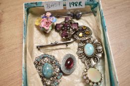 A selection of silver and costume brooches, including paste set and statement pieces