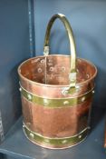 A late 19th/early 20th century copper and brass coal bucket having riveted construction and carry
