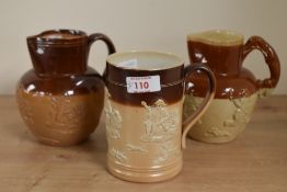 A Victorian Doultan Lambeth stoneware pitcher having hound handle and decorated with hunting