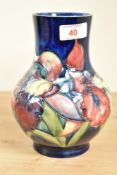 A Moorcroft pottery 'Orchid' pattern vase, tub lined with a band of flowers against a navy ground,