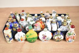 A quantity of Chinese snuff bottles decorated with various traditional scenes, to include landscape,