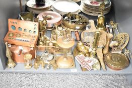 A quantity of brass and copper ware, to include a horse grooming/singing brush, a brass wall