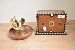 A ship wheel nut cracker, h12cm, sold together with a cigarette box, (2)