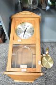 A Hermle 8 day wall clock with pendulum, h63cm