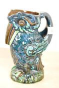 An Arts and Crafts style ceramic stork figure jug, painted to base No '621', h16.5cm