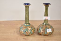 A pair of Royal Doulton stoneware vases of bottle form, decorated in the Art Nouveau style having