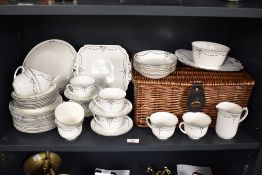 A Shelley fine bone china tea service, decorated with floral patterns on a white ground, makers mark