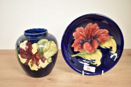 A Moorcroft pottery 'Climatus' pattern plate, having tub lined floral decoration on a cobalt blue