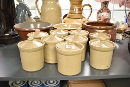 A group of stoneware storage jars with covers, h14cm, sold together with a slipware dairy bowl