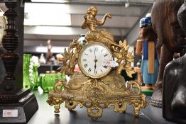 A late 19th / early 20th century gilt metal mantel clock in the classical style having acanthus leaf