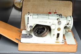 A cased singer sewing machine, label to side for 'The Singer Manufacturing Co', L50cm