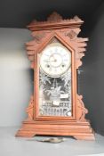 A late 19th century Ansonia (U.S.A) 'Gingerbread' clock having single gong chime and carved