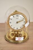 A mid - century 'Kundo' 400 day brass mantel clock with glass dome, h16
