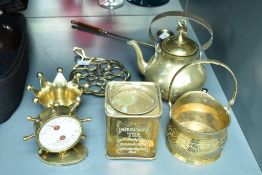 An early 20th century brass ships wheel thermometer, h12.5cm, sold together with a tea pot, candle