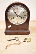 An early 20th century Wales and McCulloch 8 day mahogany mantle clock, having arched top decorated