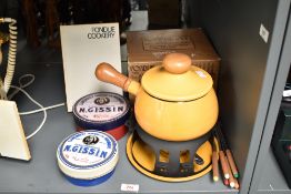 A yellow enamele fondue set, cap 1.9L, sold together with a ceramic N.Gissin dish with cover and a