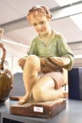An Art Deco style cast plaster painted figure of a kneeling boy, Impressed marks to reverse 'OP 375,