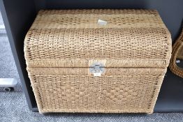 A woven wicker trunk having metal latch and presented in good condition, w74cm x h58cm