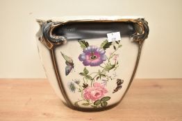 A large ceramic Art Neavoue style jardinière, decorated with floral patterns and exotic butterfly's,