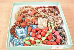 Two strings of beads of assorted forms including wooden beads, hematite, polished stone, woven
