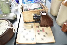 A vintage Dux Episcop bakelite projector with box, sold together with a stamp album